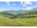 Expansive land featuring views of lush greenery, rolling hills, and distant mountains at 9105 W Freiburg Pl, Littleton, CO 80127