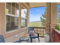 Cozy covered porch with seating and views of the open space and rolling hills at 9105 W Freiburg Pl, Littleton, CO 80127