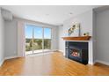 Spacious living room boasts a fireplace, hardwood floors, and a large sliding door to a balcony with neighborhood views at 9019 E Panorama Cir # D418, Englewood, CO 80112