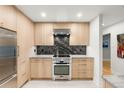 Modern kitchen features light wood cabinets and a stainless steel oven at 840 S Gaylord St, Denver, CO 80209