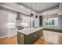 Open kitchen showcases stainless steel appliances, a center island, and hardwood flooring at 2831 W 25Th Ave # 3, Denver, CO 80211
