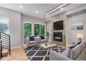 Bright living room features a modern fireplace, large windows, and stylish furnishings at 2831 W 25Th Ave # 3, Denver, CO 80211
