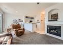 Open living room featuring a fireplace and kitchen views at 4460 S Jebel Ln, Centennial, CO 80015