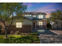 Inviting two-story home with warm lighting and a charming front porch at 20592 E Lake Ave, Centennial, CO 80016
