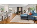 Open concept living room featuring hardwood floors, fireplace, and abundant natural light at 3194 S Milwaukee St, Denver, CO 80210