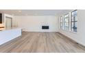 Bright living room with hardwood floors and a built-in fireplace at 15566 W Beloit Ave, Morrison, CO 80465