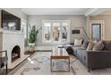 Comfortable living room with fireplace, large windows, and stylish decor at 1626 Albion St, Denver, CO 80220