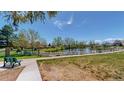 Scenic community view with a bench overlooking a serene pond surrounded by lush greenery at 39 S Scott Dr, Broomfield, CO 80020