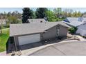 Exterior view of the home showing the attached two-car garage and well-maintained landscaping at 39 S Scott Dr, Broomfield, CO 80020