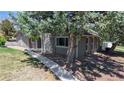 Charming exterior of a home with mature trees and a stone accent wall at 39 S Scott Dr, Broomfield, CO 80020