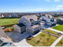 Expansive aerial view of a modern home with a spacious driveway and well-kept lawn at 437 Buckskin Rd, Berthoud, CO 80513