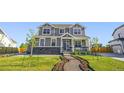 Beautiful home with stone accents, manicured lawn, and charming front porch at 437 Buckskin Rd, Berthoud, CO 80513