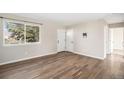 Bright living room featuring hardwood floors, a double door entry, and a large window at 6147 Dunraven, Golden, CO 80403