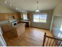 Eat in kitchen with wood floors, island and lots of natural light at 10067 Idalia St, Commerce City, CO 80022