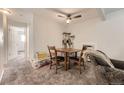 Dining area features a table with seating for two, ceiling fan, and carpeted flooring at 4653 S Lowell Blvd # E, Denver, CO 80236