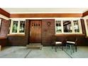 Inviting covered front porch with brick accents, seating, and a classic wood front door, creating a welcoming entrance at 723 Steele St, Denver, CO 80206