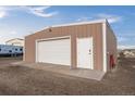Metal shed, with a roll-up door, single entry door, and concrete pad at 44011 Morning Star Ct, Elizabeth, CO 80107