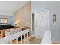 Inviting entryway with natural wood accent wall and tiled floor offers a convenient mirror at 4009 Wonderland Hill Ave, Boulder, CO 80304