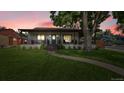 Charming single-story home featuring a welcoming front porch and lush green lawn at 2990 S Sherman St, Englewood, CO 80113