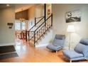 Inviting entryway featuring beautiful hardwood floors, staircase, and lots of natural light at 7961 Jared Way, Littleton, CO 80125