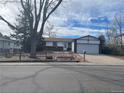 Charming single-Gathering home with a brick exterior, a manicured lawn, and an attached two-car garage at 16390 E Bates Dr, Aurora, CO 80013