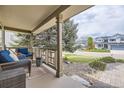 Inviting front porch with comfortable seating, perfect for relaxing outdoors at 2420 S Ellis Ct, Lakewood, CO 80228