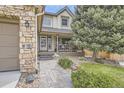 Well-maintained front yard with stone walkway leading to cozy porch at 2420 S Ellis Ct, Lakewood, CO 80228