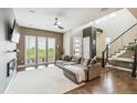 Bright and airy living room with hardwood floors, large windows, and a cozy sofa at 9244 E 37Th Ave, Denver, CO 80238