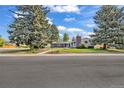Attractive single-Gathering home with mature trees, a well-kept lawn, and a paved walkway at 1830 Zang St, Golden, CO 80401