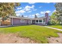 Charming brick home featuring a well-manicured lawn and a unique architectural style at 1830 Zang St, Golden, CO 80401