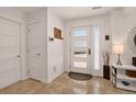 Inviting foyer with modern door, travertine floor, and elegant decor at 1688 Pine Valley Rd, Evergreen, CO 80439