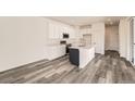 Modern kitchen with white cabinets, stainless steel appliances and an island at 1236 S Algonquian St, Aurora, CO 80018