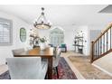 Bright dining room featuring an elegant chandelier, a decorative rug and a view of the front yard at 3418 Elk Ct, Broomfield, CO 80020