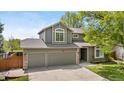 Charming two-story home featuring a well-manicured lawn, mature tree, and a two-car garage at 3418 Elk Ct, Broomfield, CO 80020