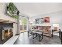 Cozy living room features a fireplace, sliding doors to a deck, and a modern design at 9519 W Coal Mine Ave # F, Littleton, CO 80123