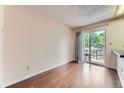 Open floorplan dining room featuring wood floors and sliding glass door at 4130 E 94Th Ave # B, Thornton, CO 80229