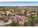 Expansive aerial view of the home nestled within a lush landscape with mountain views at 4605 Tierra Alta Dr, Castle Rock, CO 80104
