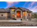 Elegant home featuring a stone facade and arched entryway, creating a welcoming and sophisticated entrance at 4605 Tierra Alta Dr, Castle Rock, CO 80104