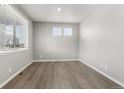 Neutral bedroom featuring wood-look floors and lots of natural light at 2248 Rosette Ln, Castle Rock, CO 80104