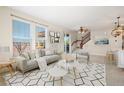 Spacious living room with a gray sofa and access to a deck at 2388 W 165Th Pl, Broomfield, CO 80023
