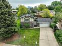 An elevated view of a brick and siding home showing the driveway and surrounding landscape at 9642 Meade Ct, Westminster, CO 80031