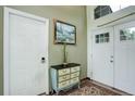 Bright entryway featuring tile floors, a decorative chest, and a view of the front door at 9642 Meade Ct, Westminster, CO 80031