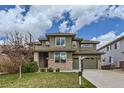 Inviting two-story home with a well-manicured lawn and inviting entrance at 4406 Sidewinder Loop, Castle Rock, CO 80108