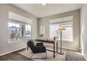 Bright office space with large windows, plush chair, and functional workspace at 4406 Sidewinder Loop, Castle Rock, CO 80108