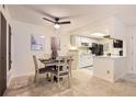 Cozy dining area featuring a modern ceiling fan, stylish table setting, and adjacent kitchen access at 18064 E Ohio Ave # 103, Aurora, CO 80017