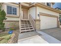 Close-up of the home's entryway with stairs leading to the front door and an ADT security sign at 20112 E Grand Pl, Aurora, CO 80015