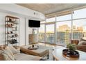 Well-lit living room with a balcony that showcases skyline views at 1700 Bassett St # 2216, Denver, CO 80202