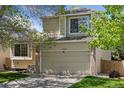 Inviting two-story home with a spacious two-car garage, brick accents and well-maintained lawn at 17611 Hoyt Pl, Parker, CO 80134