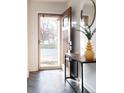 Inviting entryway featuring herringbone floors, stylish table, and modern decor at 3004 S Niagara Way, Denver, CO 80224
