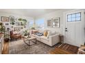 Bright living room with comfy furniture, gallery wall, and hardwood floors at 1280 Macon St, Aurora, CO 80010